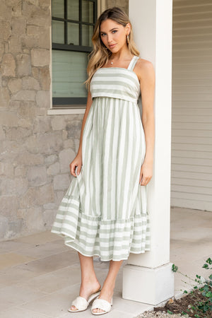 Front view of Soren tie-back midi dress in heather sage and cream stripes, square neckline and hidden side pockets on model.