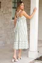 Close-up of adjustable tank straps and square neckline on Soren sage stripe midi dress, highlighting strap hardware and stitching.