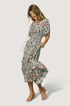 Inset image showing the dress lining and mid-thigh coverage of the slip beneath the sage and pink floral midi dress.