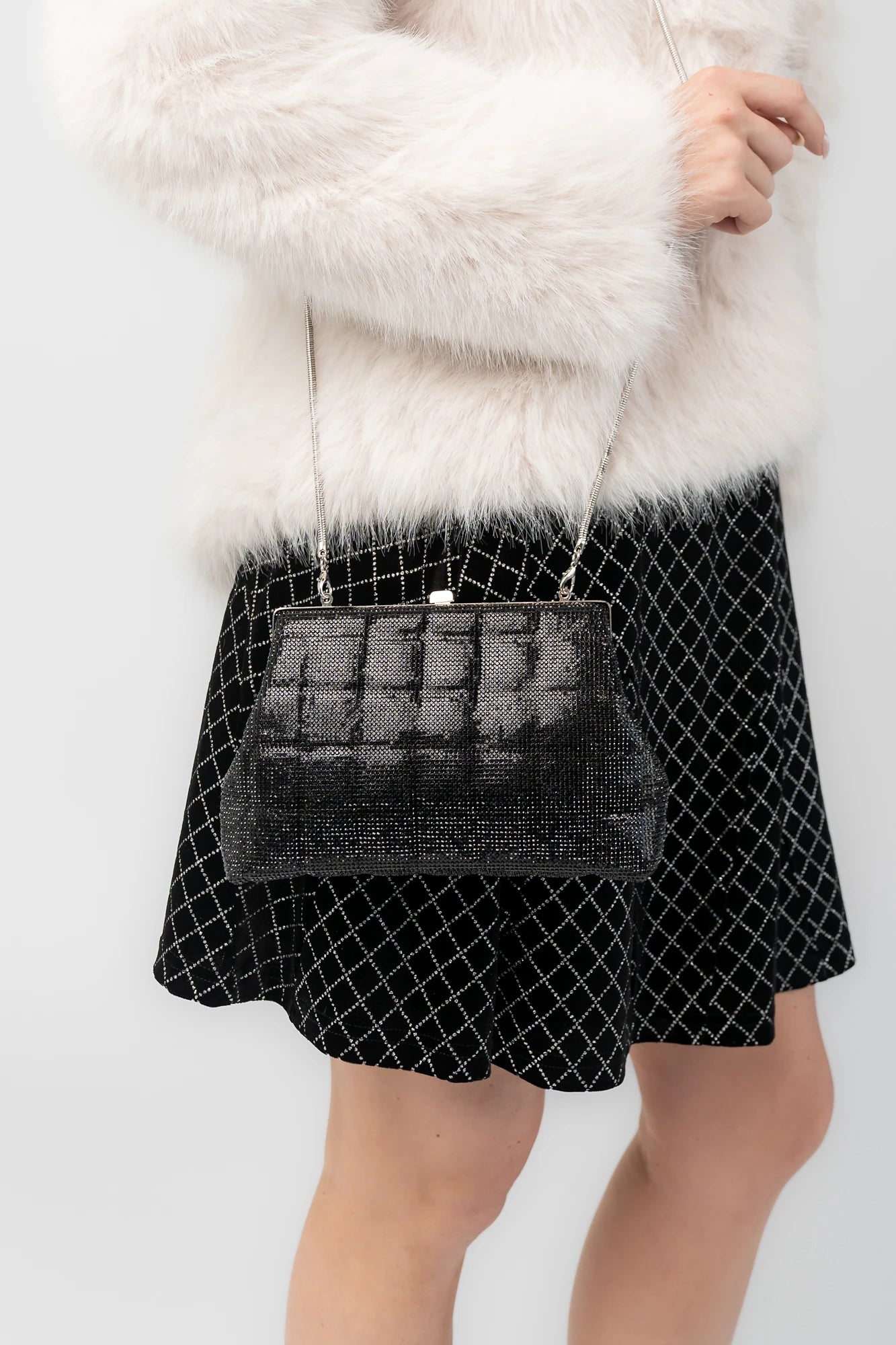 Starlight Evening Clutch Bag with black rhinestones, structured silhouette, clasp closure, and detachable chain strap.