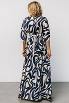 Close-up of the ivory multi print and silky satin texture with visible subtle sheen and navy-blue patterning detail.