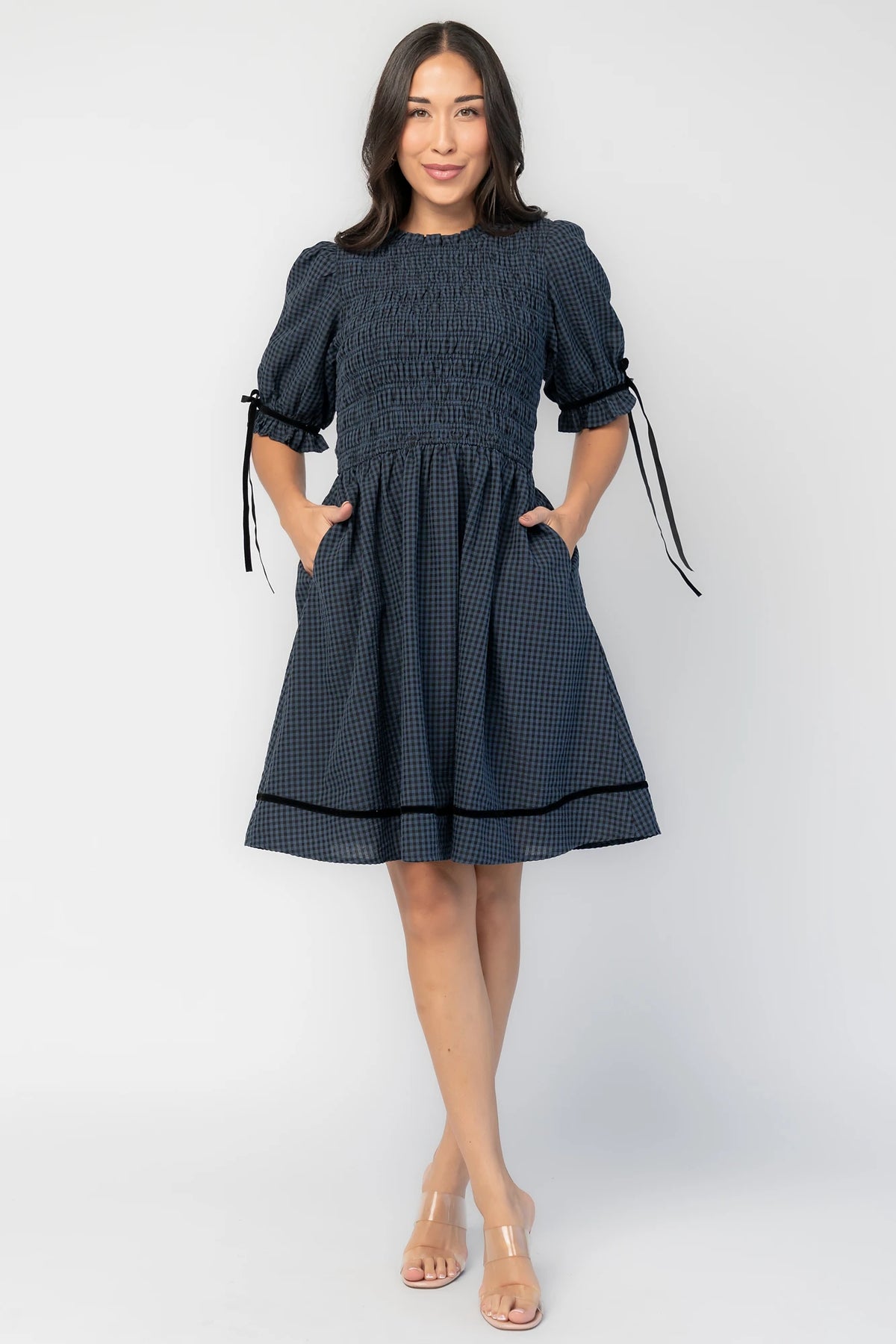 Susan Short Dress in Navy + Black Gingham with smocked bodice, elbow-length sleeves, black velvet ties, and velvet-trimmed hem.