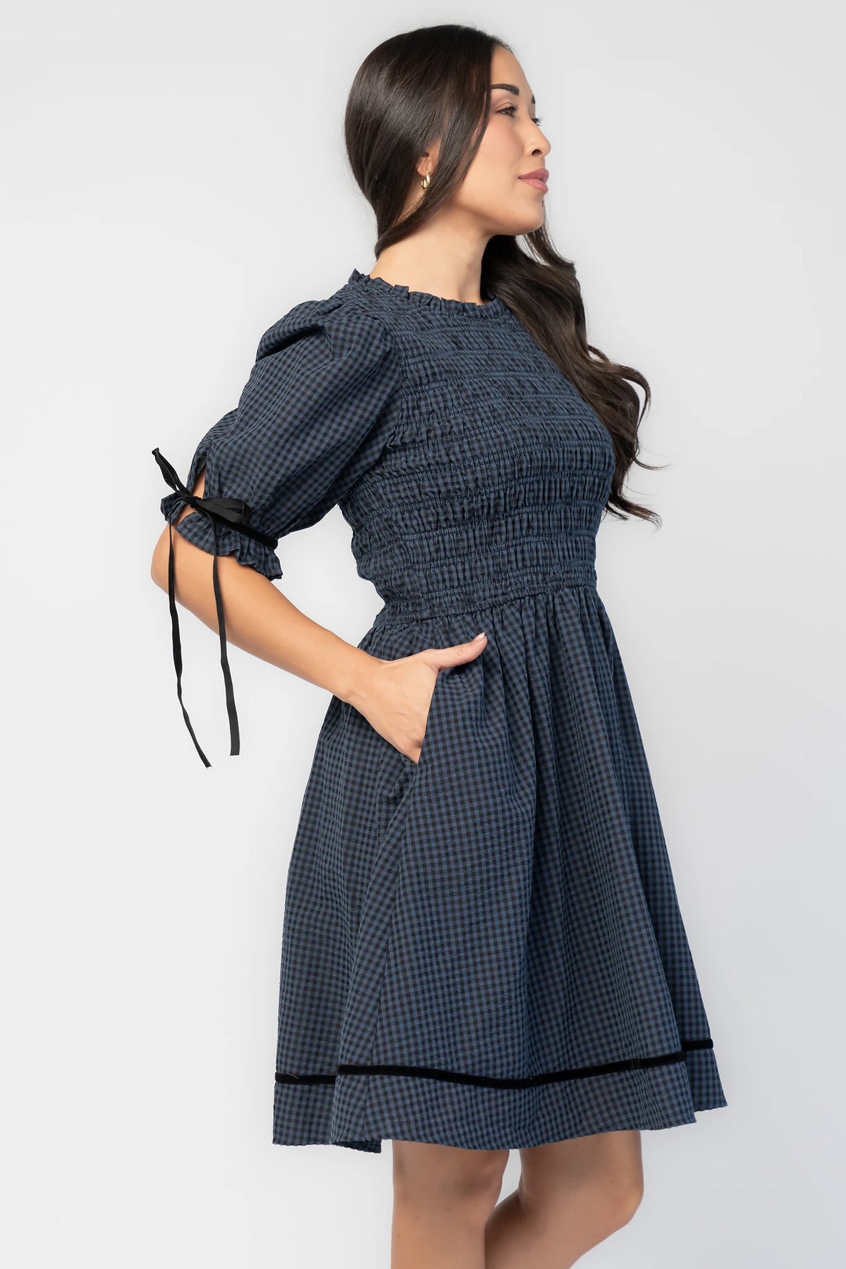Susan Short Dress in Navy + Black Gingham with smocked bodice, elbow-length sleeves, black velvet ties, and velvet-trimmed hem.