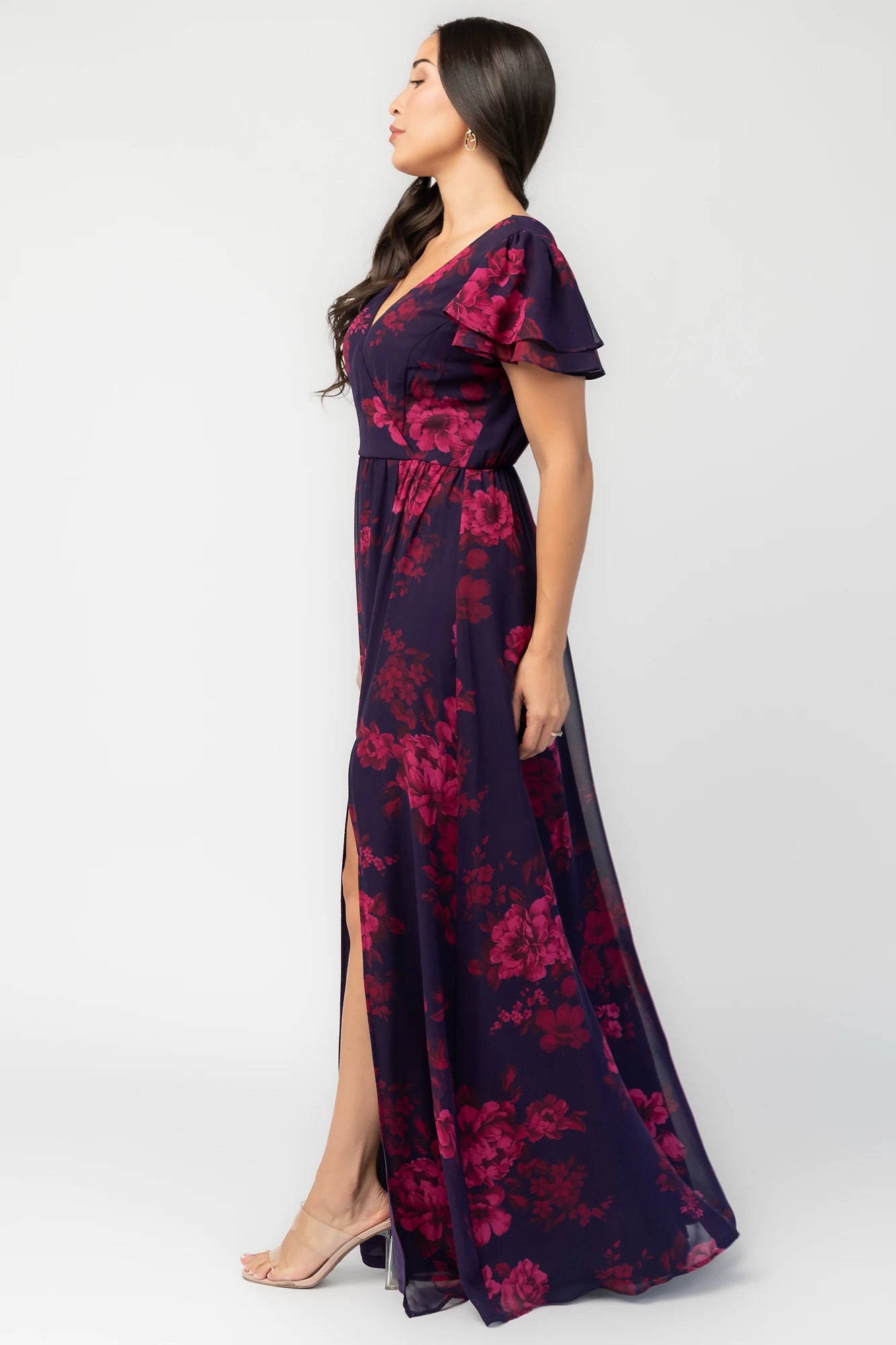 Theodora Maxi Dress in Indigo + Berry with floral print, crossover V-neck, flutter sleeves, elastic waist, and leg slit.