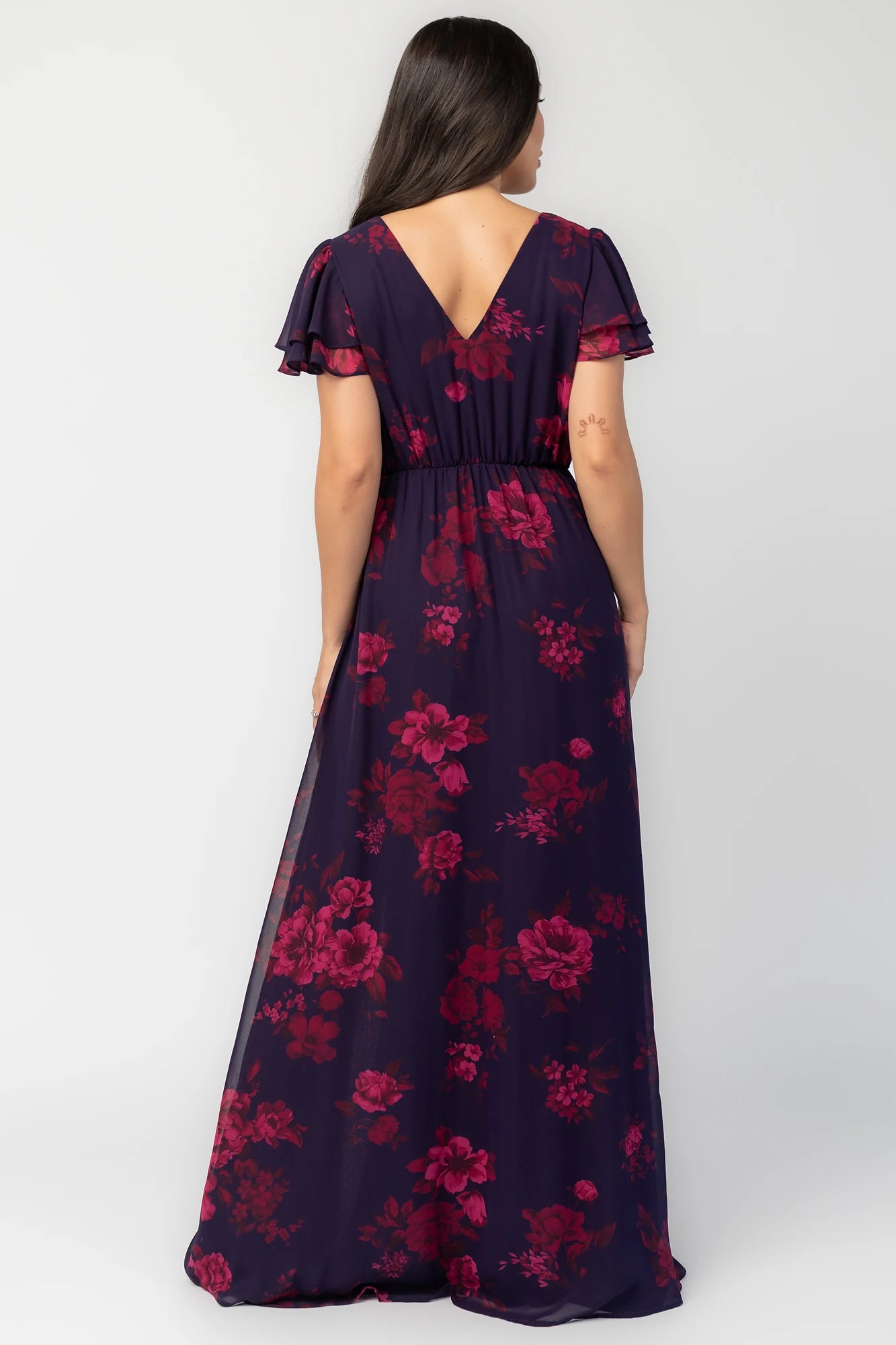Theodora Maxi Dress in Indigo + Berry with floral print, crossover V-neck, flutter sleeves, elastic waist, and leg slit.