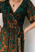 Detail shot of sleeve and bodice of Uma Velvet Maxi Dress in bronze and jade showing unlined sleeves and delicate burnout floral pattern.