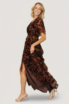 Hanging flat view of the clove velvet Uma dress with amber floral print, showing overall color, sheen, and skirt length.
