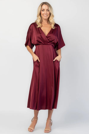 Veda Midi Dress in Burgundy with V-neckline, adjustable back tie, and hidden side pockets.