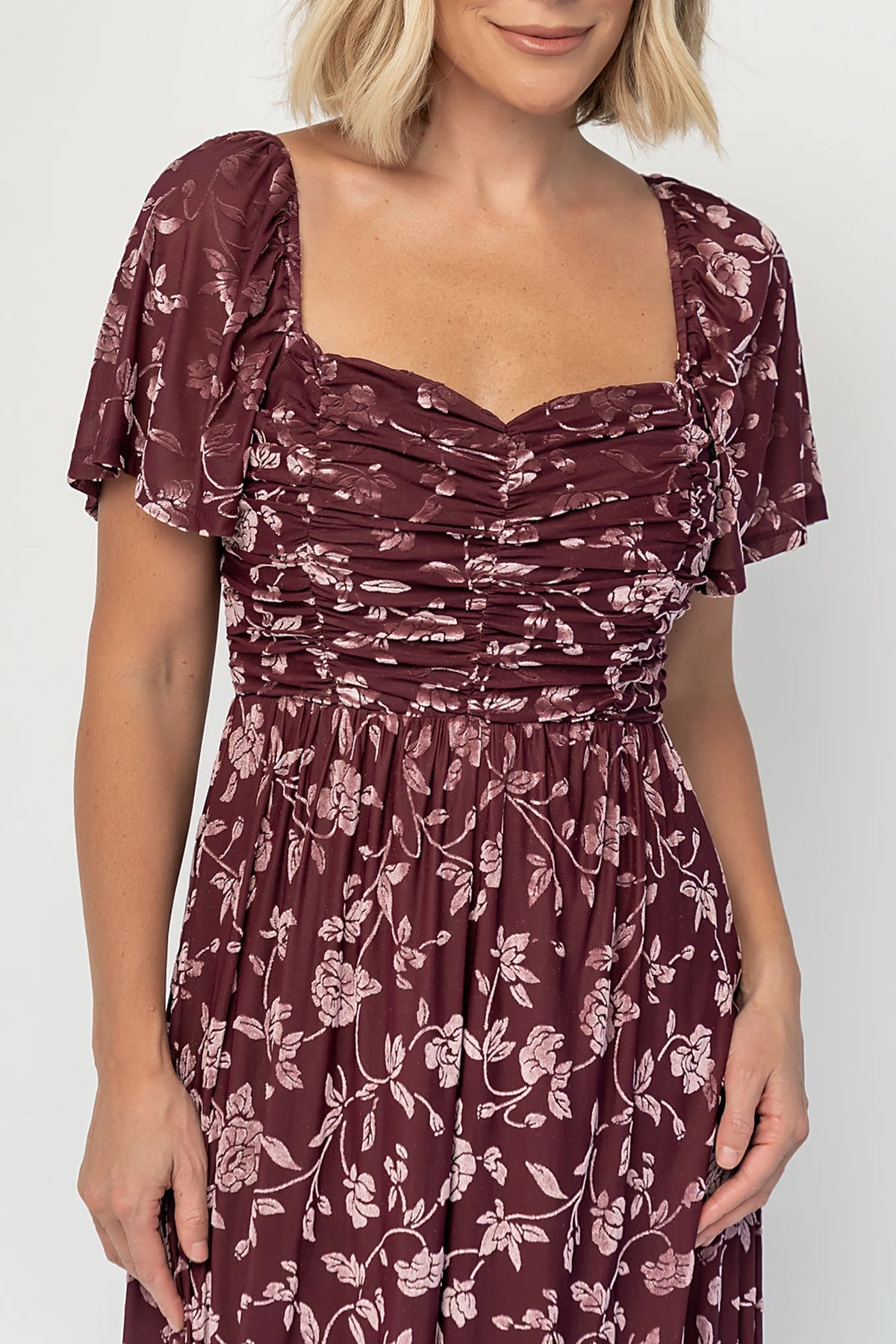 Veloura Maxi Dress in Mulberry Floral with sweetheart neckline, flutter sleeves, ruched bust, smocked back, and velvet florals.