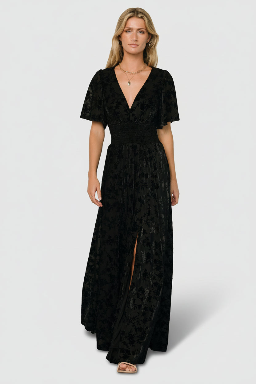 Back view of Veronica Velvet Maxi Dress in black showing full lining, gentle back drape, and smocked waist detail.