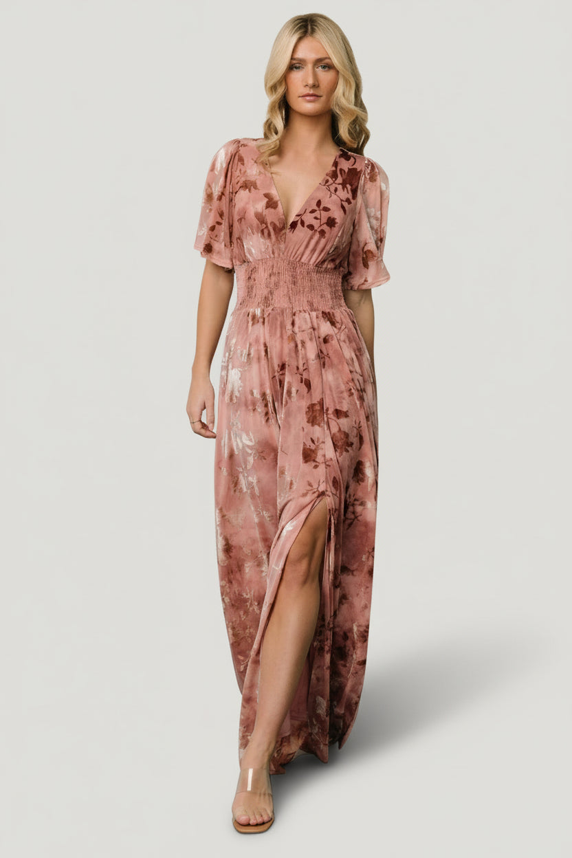 Front view of Veronica Velvet Maxi Dress in blush, showing deep V-neckline, smocked waist, flowy sleeves, and maxi hem for event wear.