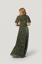 Detail view of flowy short sleeve and fabric drape on the Veronica Velvet Maxi Dress, highlighting breathable unlined sleeves.