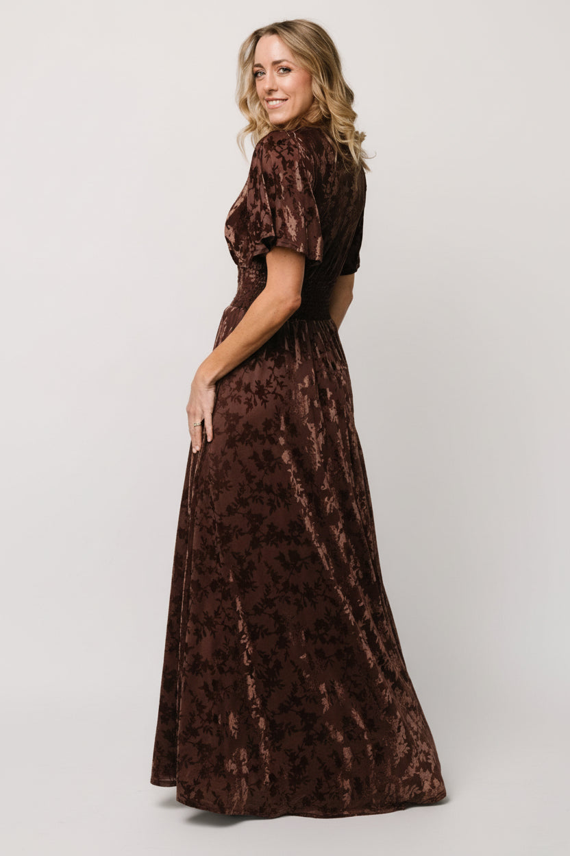 Back view of Veronica Velvet Maxi Dress in espresso showing the dress length, flowy silhouette, and how the fabric drapes from the waist.