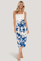 Close-up of the skirt’s tulip hem and wrap overlap, showing fabric texture and print detail with visible lightweight weave and drape.