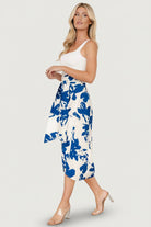Styled detail shot of the waistband and tie closure of the blue abstract floral wrap skirt, illustrating adjustability and finish details.