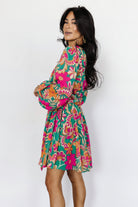 Back view of Wesley Mini Dress in green multi floral print highlighting the lined bodice, unlined sheer sleeves, and removable sash at the waist.