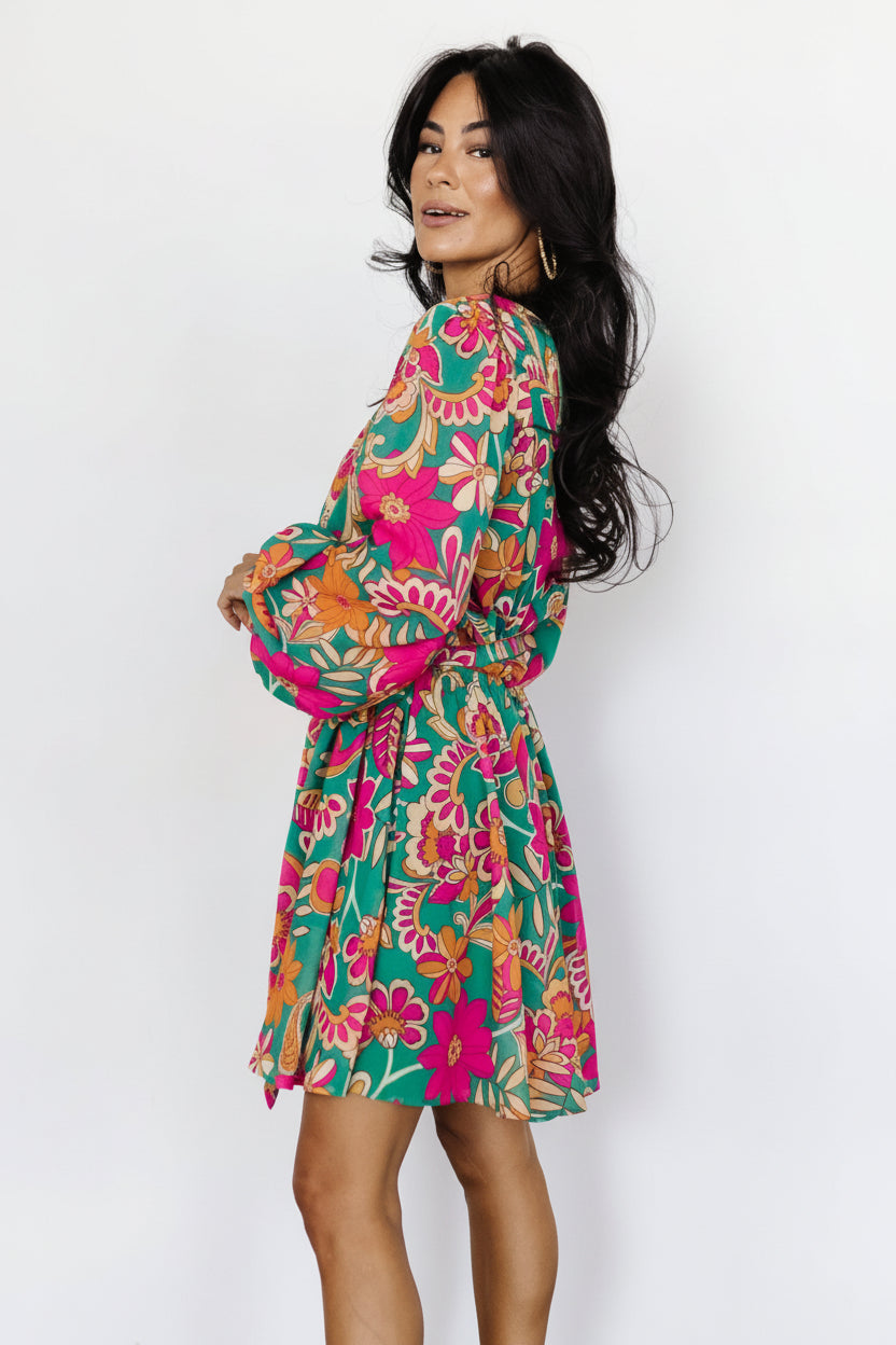 Back view of Wesley Mini Dress in green multi floral print highlighting the lined bodice, unlined sheer sleeves, and removable sash at the waist.