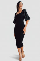 Front view of black Weyland bodycon midi dress on model, showing square neckline, embossed puff sleeves, and fitted silhouette.