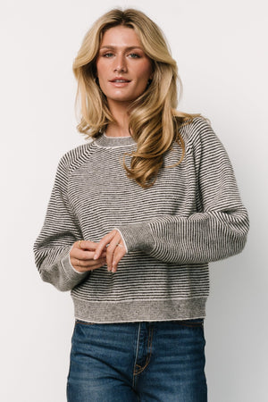 Front view of the Zadie Striped Sweater in ivory and black highlighting the high round neckline, raglan sleeves, and bold stripe pattern.