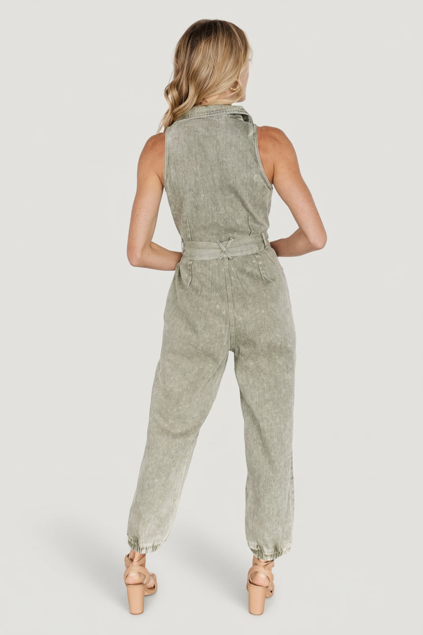 Close-up of denim fabric texture, washed olive color and removable belt tied at the waist for shape.