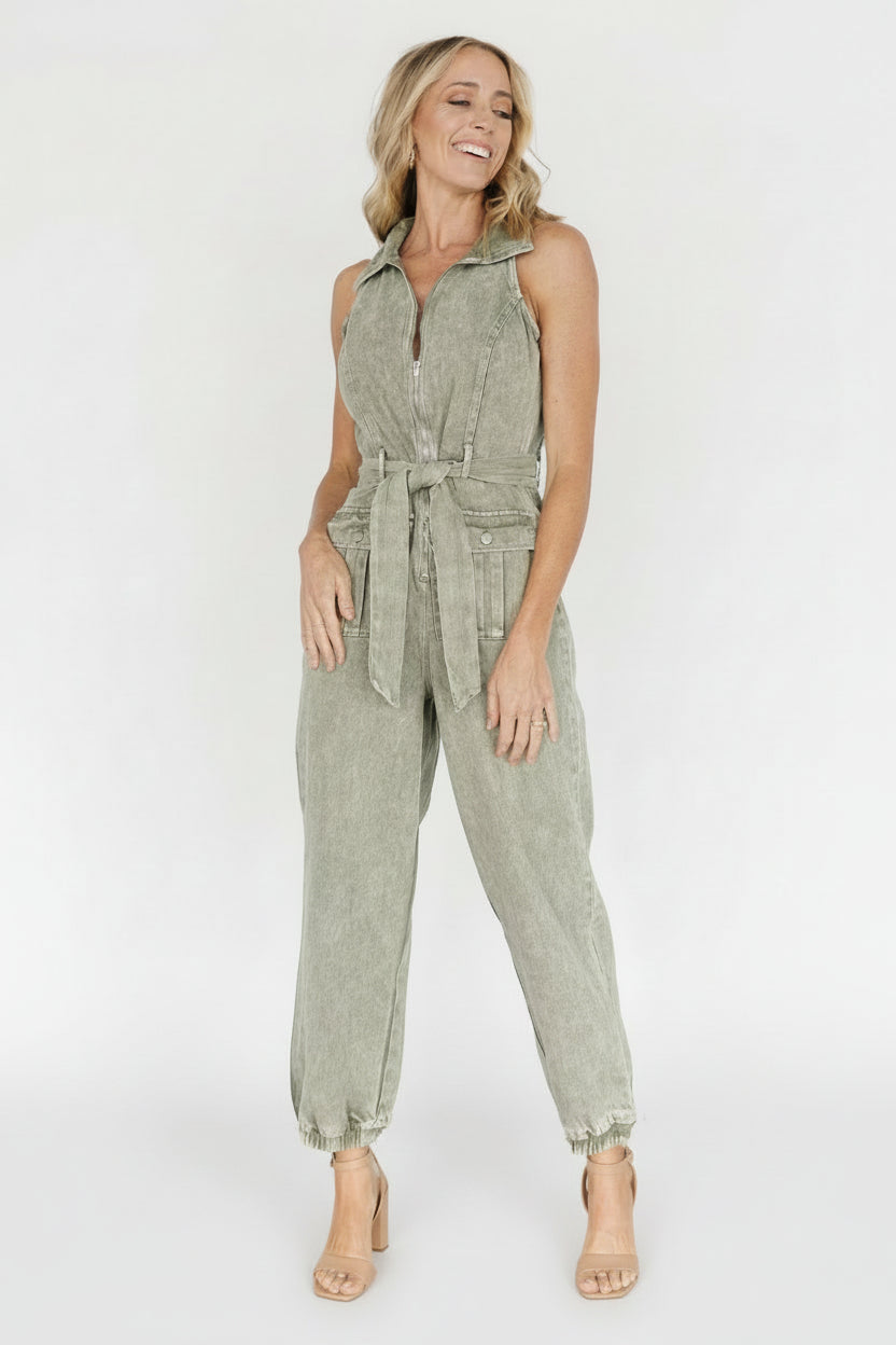 Lifestyle shot of the sleeveless jumpsuit styled with sandals, emphasizing its casual, versatile design.