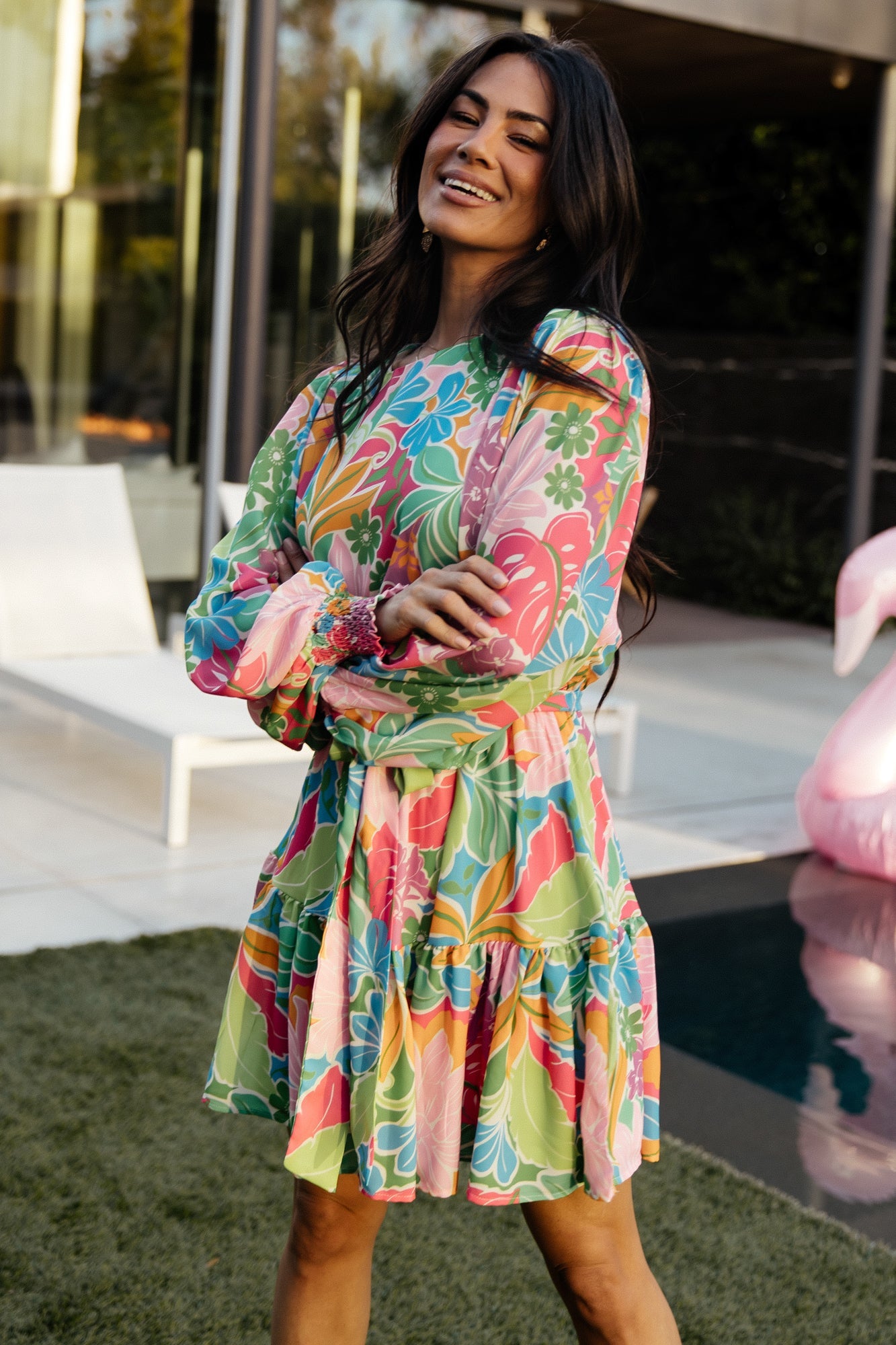 Side view of the short dress in multi floral print, showing removable waist tie and flattering tiered ruffle hem in motion.