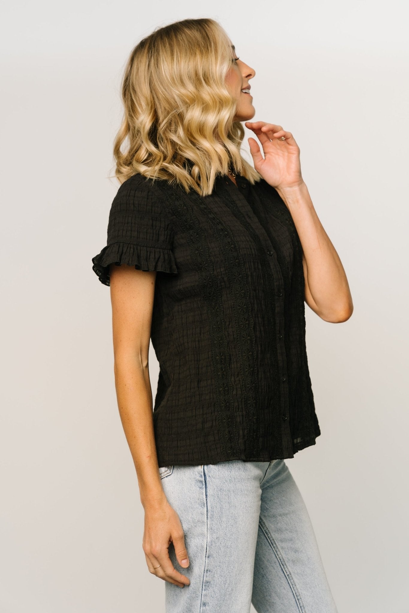 Styled outfit image of black Zara lace top paired with denim, showing overall silhouette, short ruffle sleeves, and vertical lace detailing across the front