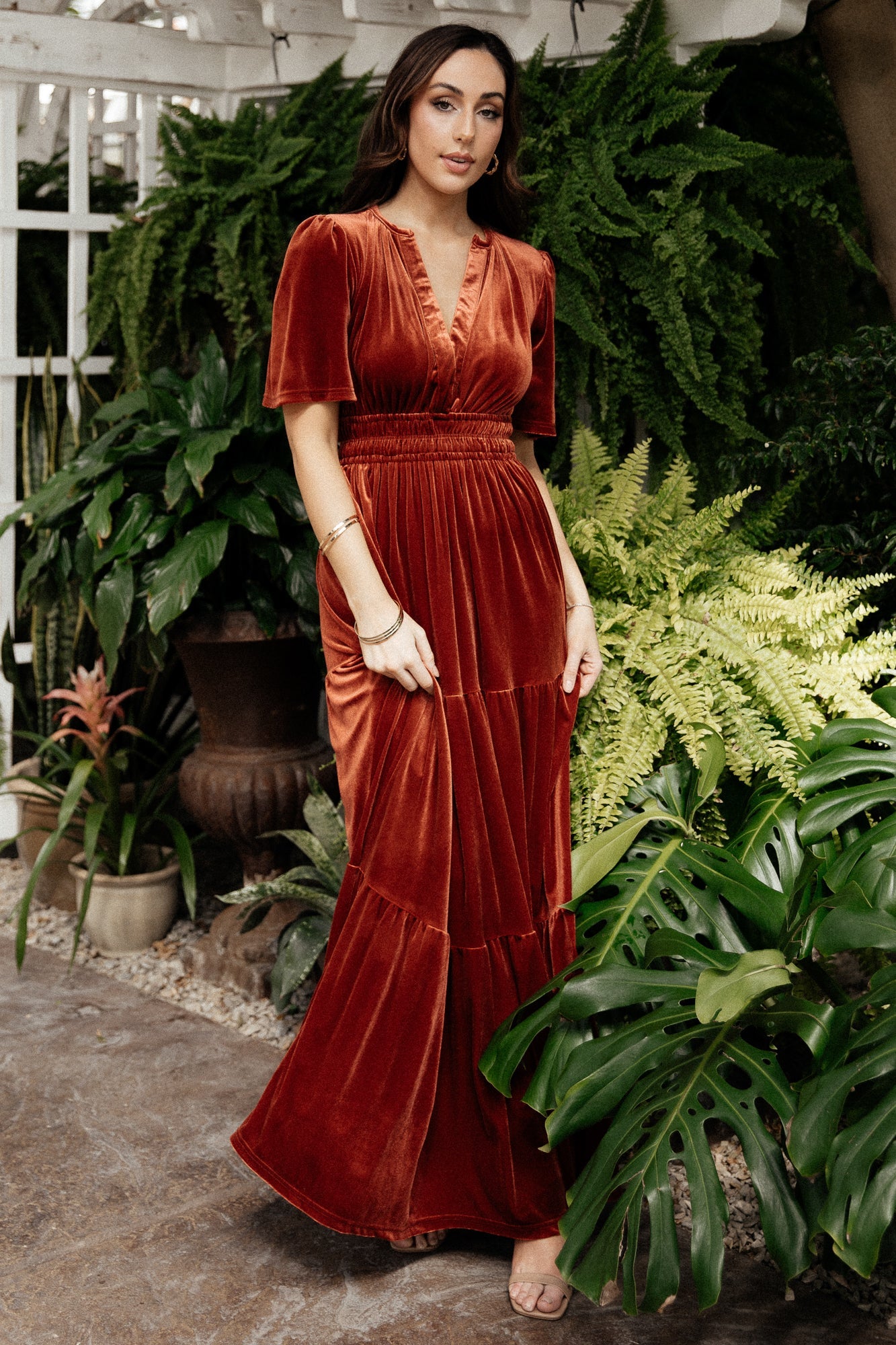 Studio product shot of the Artemis terracotta velvet maxi dress highlighting color, tiered skirt, and overall silhouette.