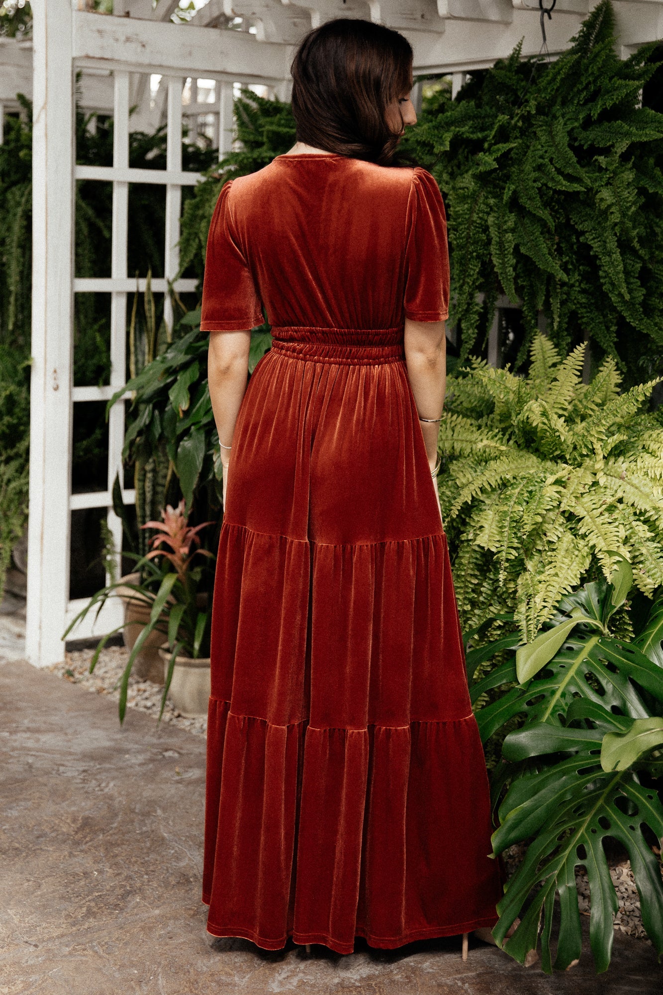 Styled look of the terracotta velvet maxi dress paired with accessories to show occasion styling for formal events.