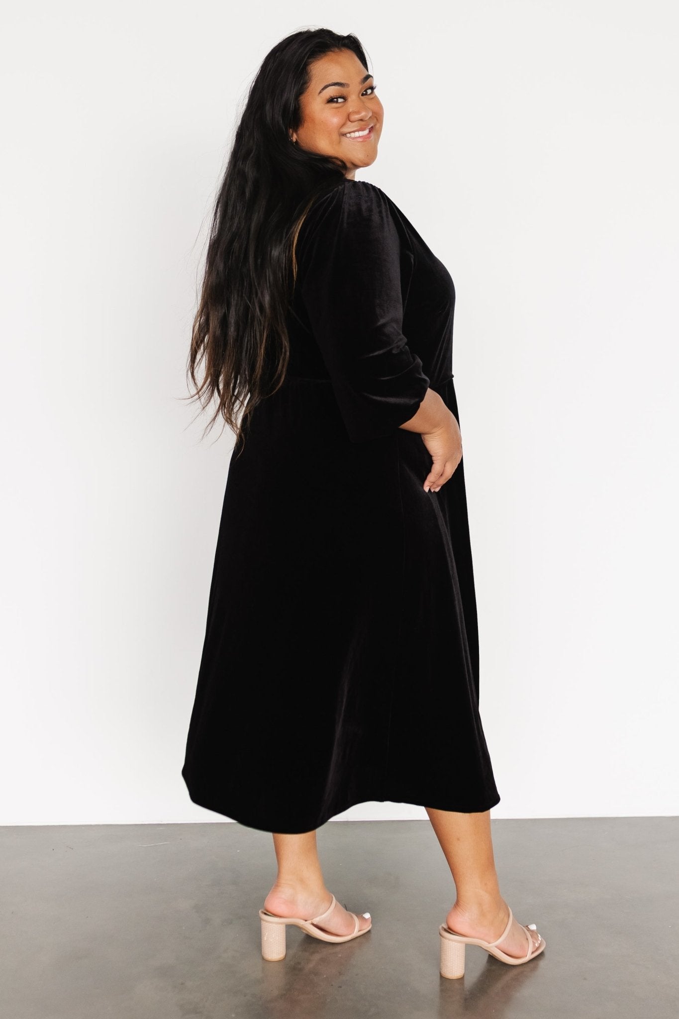 Back and side view of the velvet wrap dress illustrating length to mid-calf, smooth lining and refined evening-ready cut.