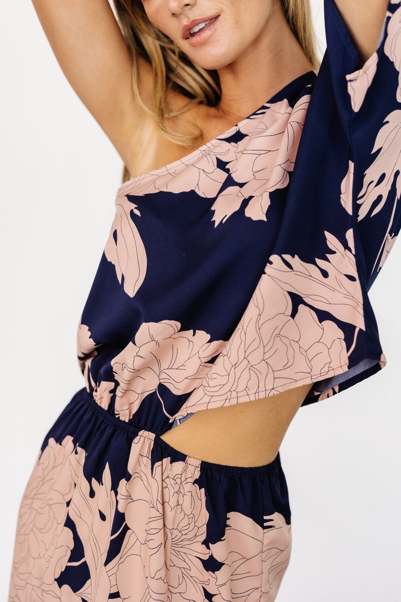 Detail view of the Halston dress's right-side zipper and waistline area, illustrating construction and how the cutout sits at the hip.