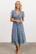 Full-length studio shot of the blue floral chiffon midi dress showing silhouette, sleeve length, and natural movement of the skirt.