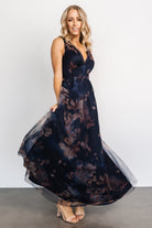 Movement shot of the dark blue floral tulle maxi dress showing layered tulle skirt in motion and its soft, voluminous drape.