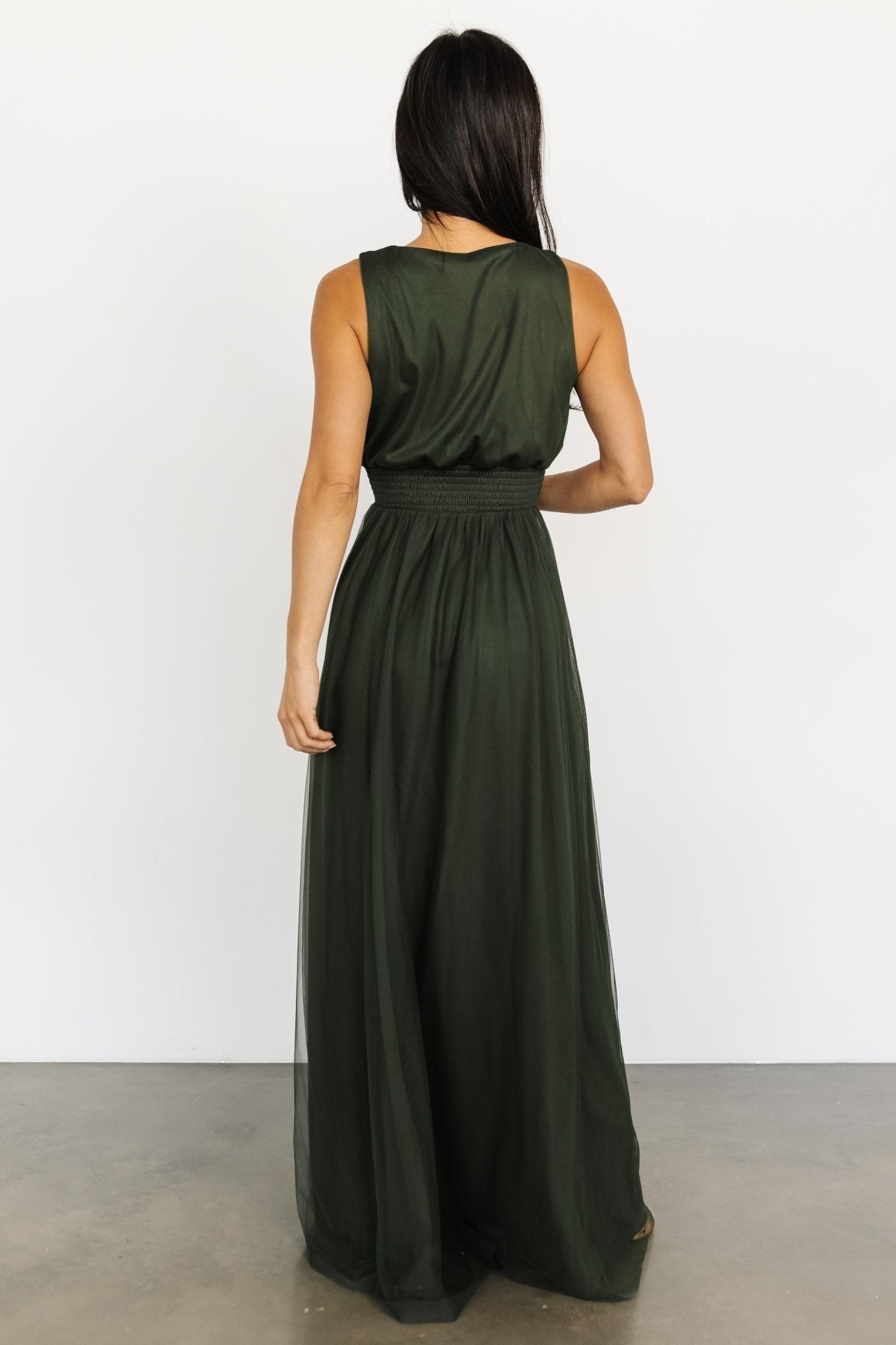 Close-up of the Kamila Tulle Maxi Dress Juniper Green showing smocked waist detail, delicate tulle overlay, and smooth lining underneath.