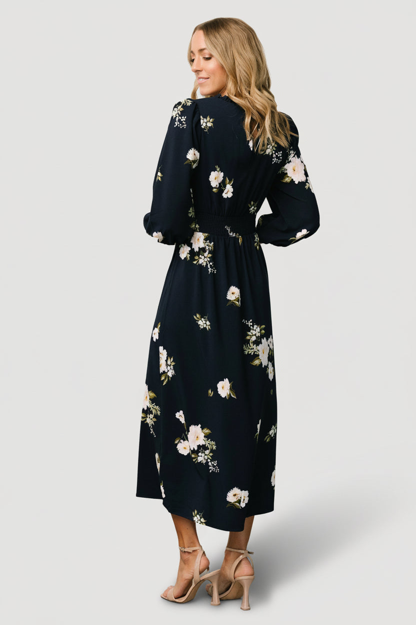 Fabric detail of polyester-chiffon blend showing lightweight weave and navy with ivory floral motifs for close inspection.