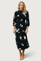 Three-quarter view of Karalie maxi dress with mid sleeves and elastic cuffs, highlighting sleeve volume and print placement.