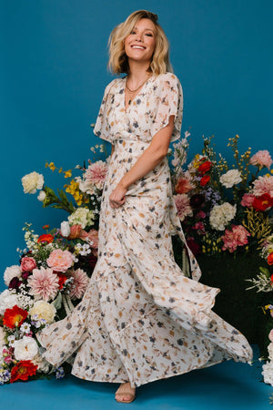 Front view of Katherine maxi dress in cream multi floral; chiffon overlay, surplice neckline, flutter sleeves.