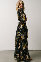 Side view of the maxi skirt showing the left-side leg slit and the skirt lining visible at mid-thigh under the overlay.
