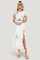 Three-quarter angle of cream floral Kirsten Midi Dress, highlighting short sleeves, delicate chiffon print, and flowing A-line skirt.
