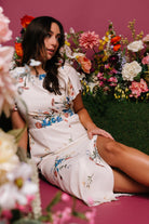 Detail photograph of neckline and short sleeves on the Kirsten Midi Dress, showing keyhole closure, soft ruffle trim, and lightweight fabric.
