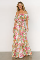 Back view of the Lahaina off-shoulder maxi dress on model, showing elastic neckline, tiered hem, and partial skirt lining.