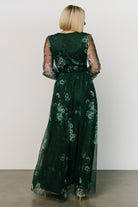 Side view of Layla Tulle Maxi Dress in Dark Green Multi showing silhouette, raw hem length, and how the skirt moves with each step on model.