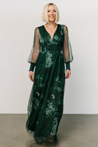 Back view of Layla Tulle Maxi Dress in Dark Green Multi displaying smocked waist, flowing skirt, and long sleeves with smocked cuffs for refined finish.