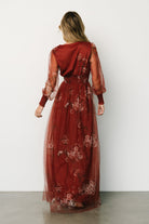 Styled look of the Layla tulle maxi dress in rust floral with accessories, highlighting overall fit, length and occasion-ready styling.