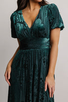 Detail view of gathered waist and seam lines on the embossed velvet maxi, showing construction and lining at the bodice.