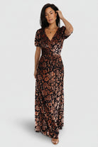 Front view of Leslie embossed velvet maxi dress in Black + Bronze showing V-neck, gathered waist, and flowing skirt for full-length silhouette.