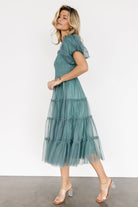 Close-up of smocked bodice and ruffle square neckline showing stretch texture, neat ruffle finish, and lined interior for coverage.