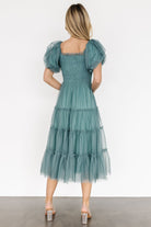 Back and sleeve detail of eucalyptus tulle midi dress showing lined bodice, ruffle puff sleeve seam and tiered back silhouette.