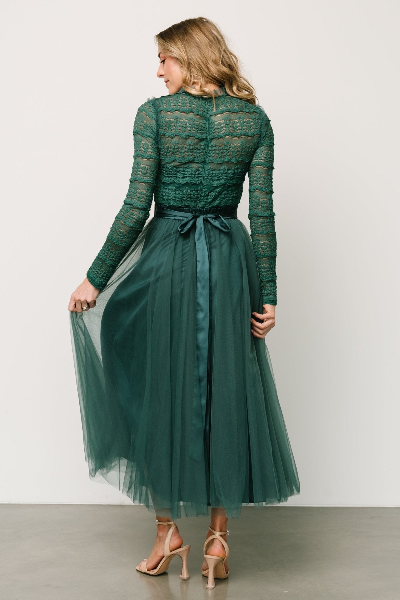Back view of the Lonnie dress showing hidden zipper at back bodice, the gathered waistline and layered tulle skirt fall.