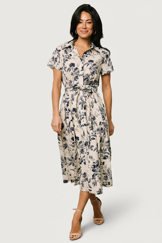 Side profile showing A-line skirt and mid-length hemline, removable waist sash, and lightweight 100% cotton fabric.